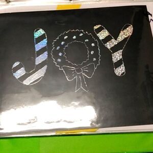 Silver engraving that says joy